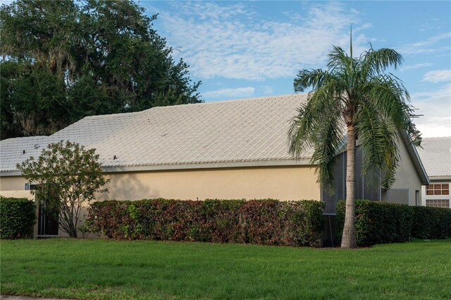 view of side of home featuring a lawn