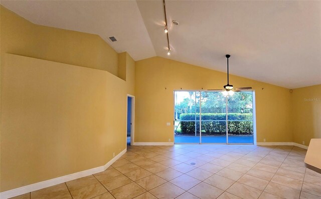 unfurnished room featuring light tile patterned floors, track lighting, ceiling fan, and lofted ceiling