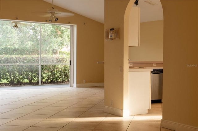 unfurnished room with light tile patterned floors, vaulted ceiling, and ceiling fan