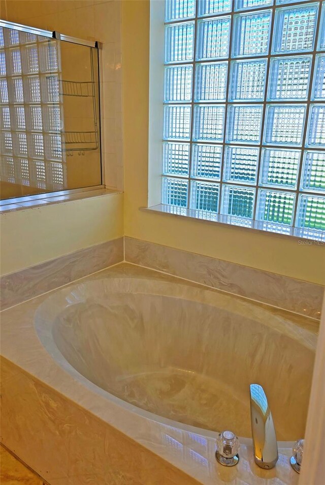 bathroom featuring tiled bath