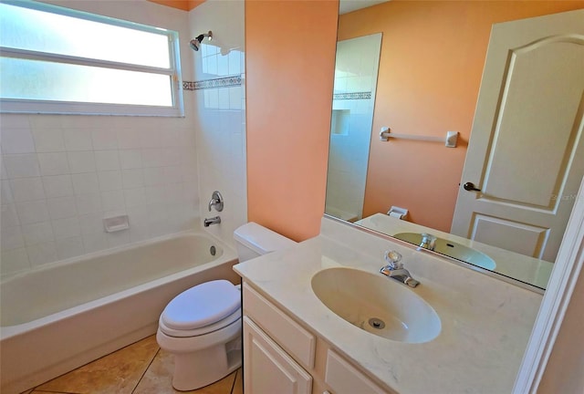 full bathroom featuring toilet, vanity, tile patterned floors, and tiled shower / bath