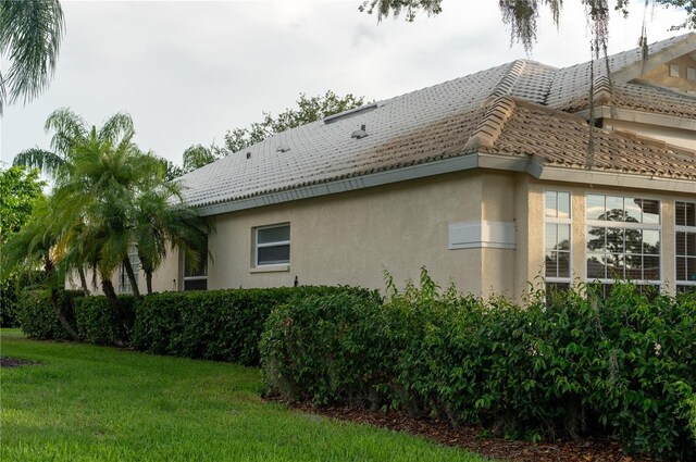 view of side of home featuring a yard