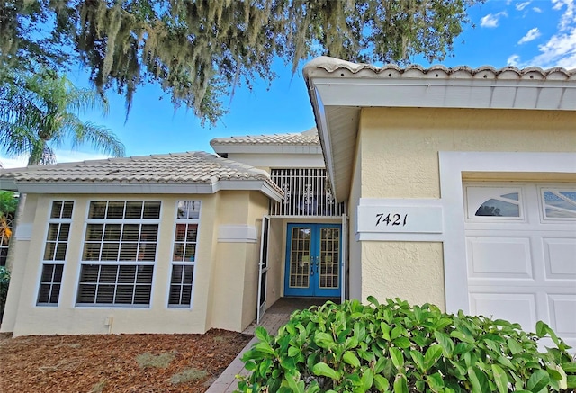 view of exterior entry featuring french doors