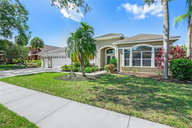 view of front of house with a garage and a front lawn