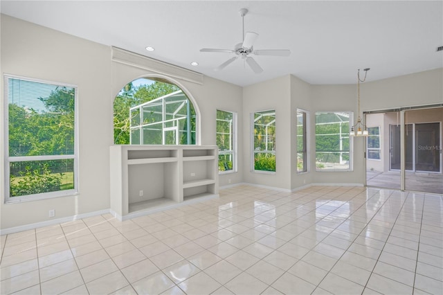 interior space with ceiling fan with notable chandelier