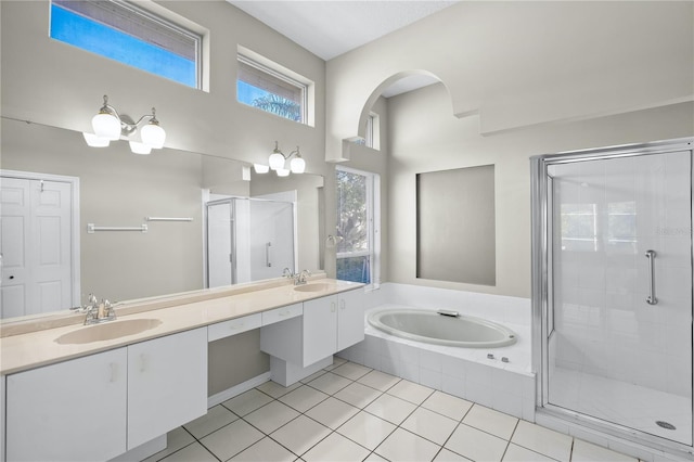 bathroom with tile patterned floors, vanity, and separate shower and tub