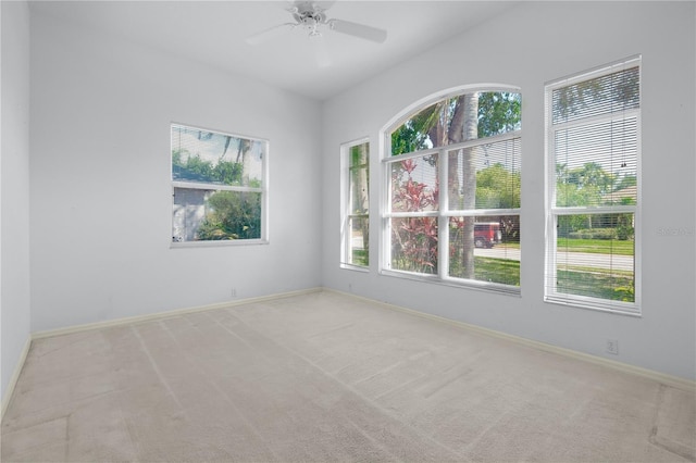 spare room with light carpet and ceiling fan