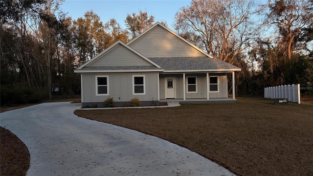 view of front of house featuring a front yard and covered porch