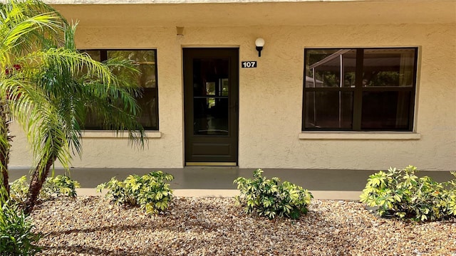 property entrance with stucco siding