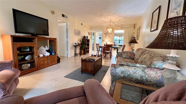 living room featuring an inviting chandelier and light tile floors