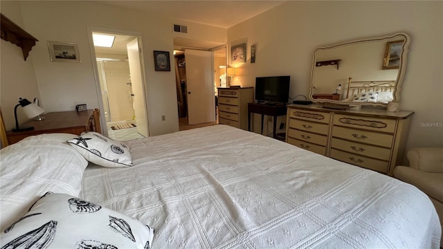 bedroom featuring visible vents and ensuite bathroom