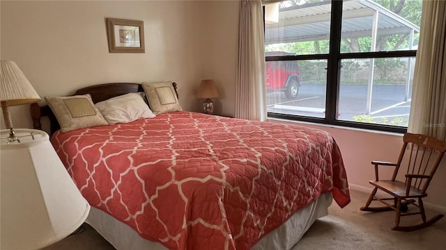 carpeted bedroom featuring multiple windows