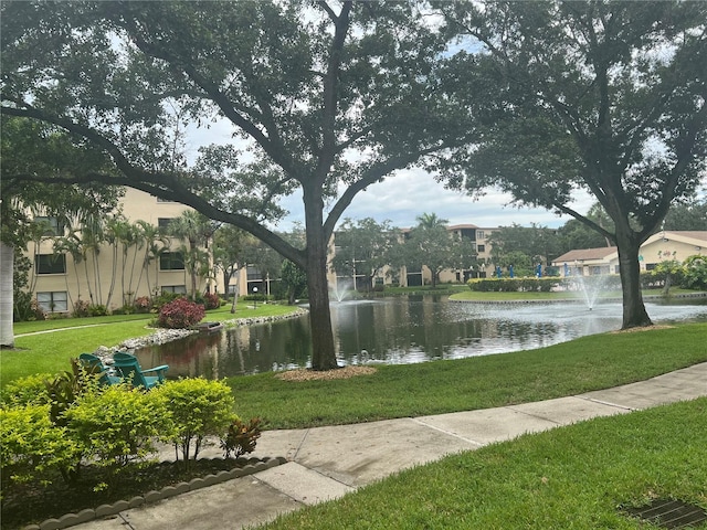 surrounding community featuring a yard and a water view