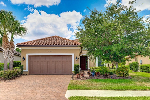 mediterranean / spanish-style house with a garage and a front yard