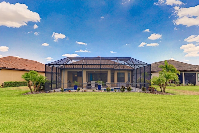 back of property featuring a lawn and a lanai