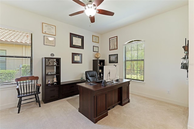 carpeted home office with ceiling fan