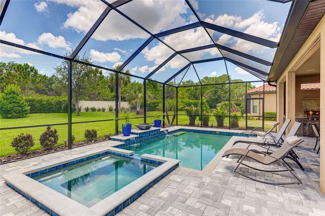 view of pool featuring an in ground hot tub, a yard, glass enclosure, and a patio area