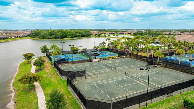 view of sport court with a water view