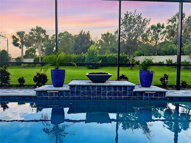 pool at dusk with a lawn