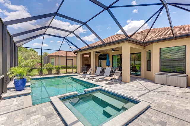 view of swimming pool with ceiling fan, a lanai, an in ground hot tub, and a patio