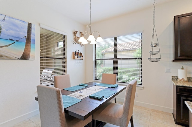 tiled dining area featuring an inviting chandelier