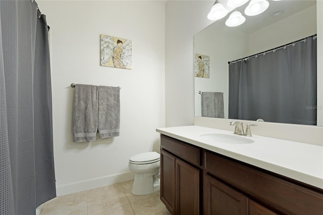 bathroom with tile patterned flooring, vanity, and toilet