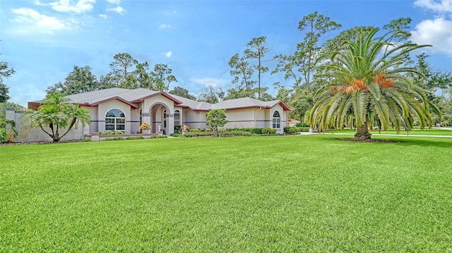 mediterranean / spanish house featuring a front lawn