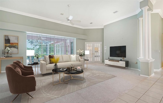 carpeted living room with ornamental molding, french doors, ceiling fan, and ornate columns