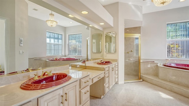 bathroom featuring a chandelier, separate shower and tub, a wealth of natural light, and vanity