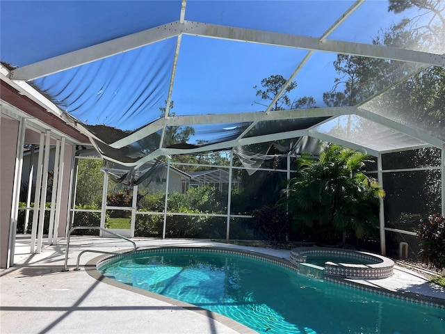 view of swimming pool with an in ground hot tub, glass enclosure, and a patio