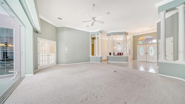 unfurnished living room featuring ceiling fan with notable chandelier, light colored carpet, french doors, and crown molding