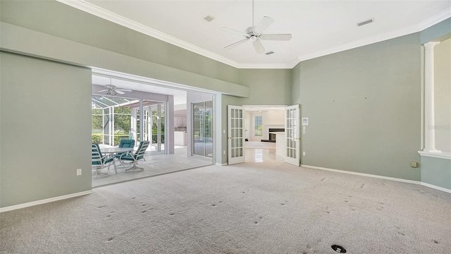 unfurnished room with decorative columns, ceiling fan, and light colored carpet