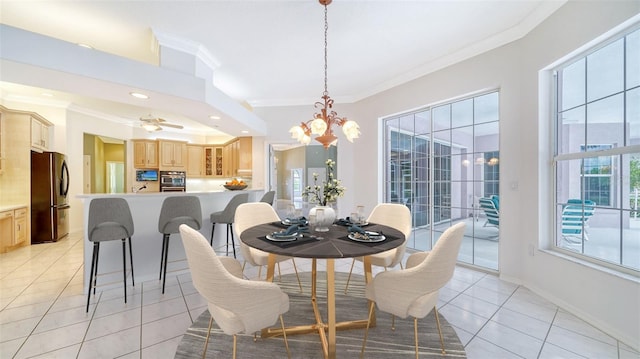 tiled dining space featuring ceiling fan with notable chandelier and crown molding