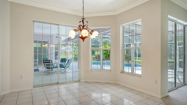 doorway featuring a chandelier, light tile patterned floors, and ornamental molding