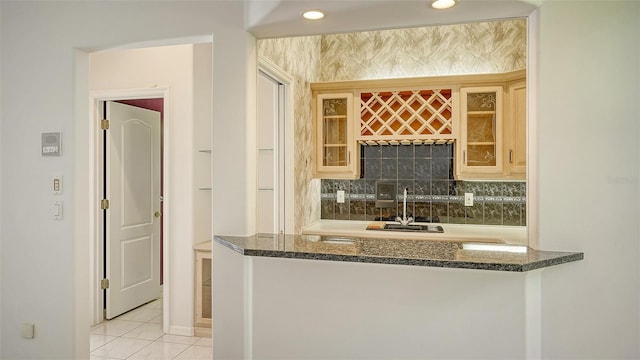 kitchen featuring light tile patterned floors and tasteful backsplash