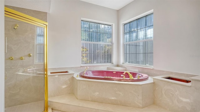 bathroom featuring separate shower and tub