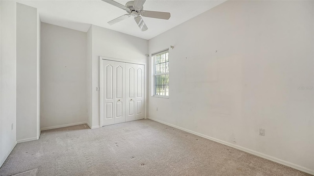 unfurnished bedroom with light colored carpet, ceiling fan, and a closet