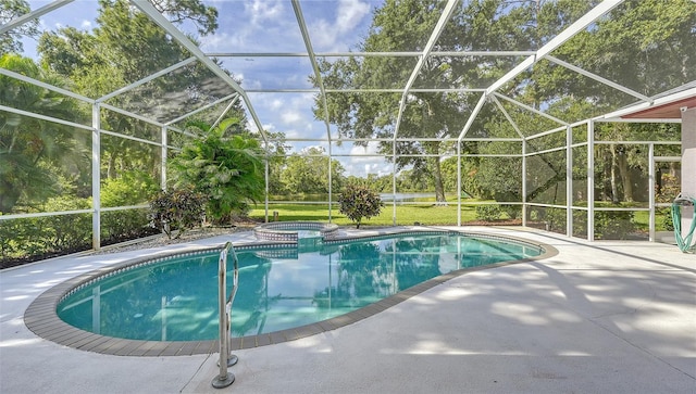 view of swimming pool featuring a patio, glass enclosure, and an in ground hot tub