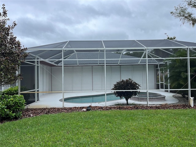 back of property with a lanai and a yard