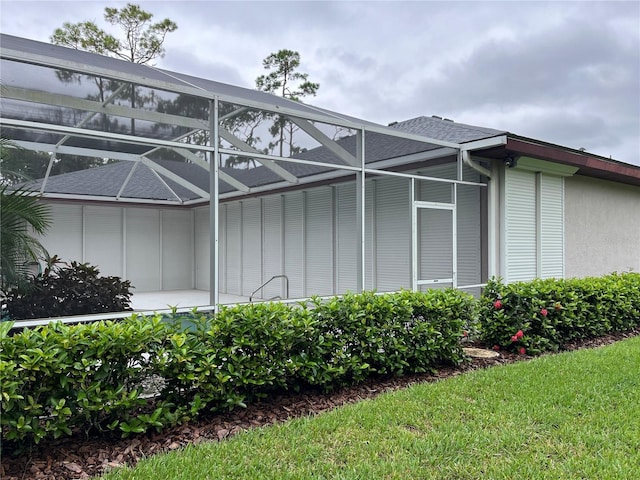 view of side of home featuring glass enclosure