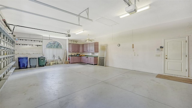 garage featuring a garage door opener and ceiling fan