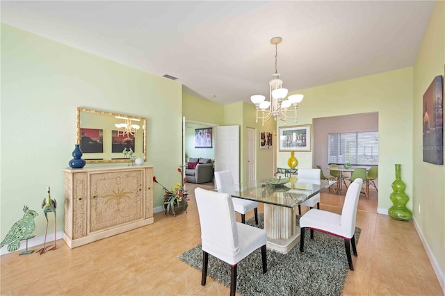 dining room featuring a chandelier and light hardwood / wood-style floors