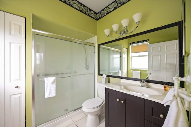 bathroom featuring tile patterned flooring, vanity, toilet, and a shower with door