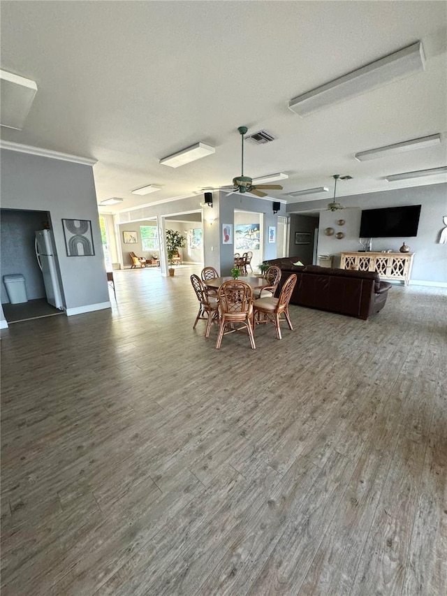 dining space featuring hardwood / wood-style floors and ceiling fan