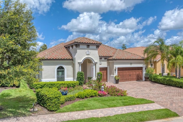 mediterranean / spanish house featuring a garage