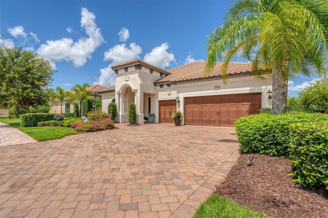 mediterranean / spanish-style home with a garage