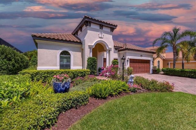 mediterranean / spanish-style house with a garage