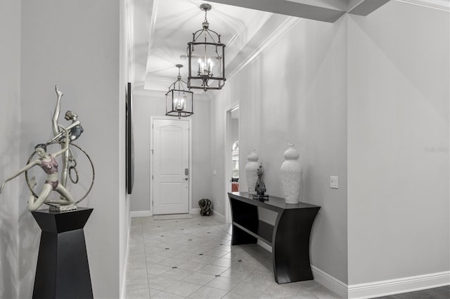 entrance foyer with a chandelier and crown molding