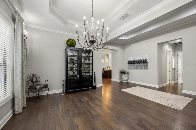 interior space featuring french doors, an inviting chandelier, a raised ceiling, dark hardwood / wood-style floors, and crown molding