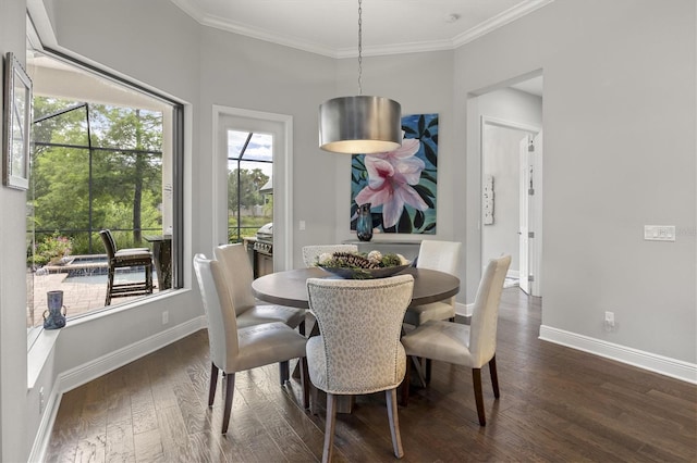 dining space with dark hardwood / wood-style floors and ornamental molding